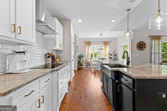 19 E Murphy St, Newnan, GA 30263 - kitchen featuring wall chimney exhaust hood, a sink, black electric cooktop, plenty of natural light, and recessed lighting