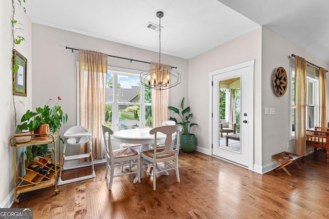 19 E Murphy St, Newnan, GA 30263 - dining space featuring a chandelier, wood finished floors, and baseboards