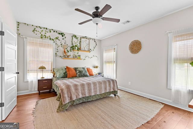 19 E Murphy St, Newnan, GA 30263 - bedroom featuring wood finished floors, multiple windows, baseboards, and ceiling fan