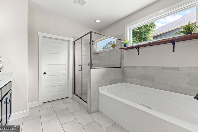 19 E Murphy St, Newnan, GA 30263 - bathroom featuring a garden tub, tile patterned floors, a stall shower, vanity, and baseboards