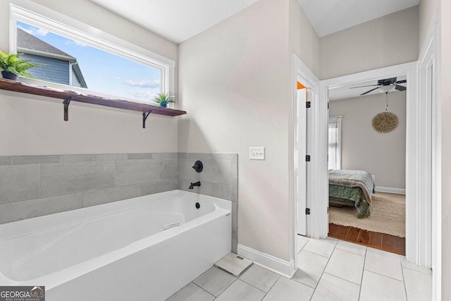 19 E Murphy St, Newnan, GA 30263 - ensuite bathroom featuring baseboards, tile patterned flooring, a bath, and a ceiling fan
