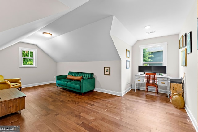 19 E Murphy St, Newnan, GA 30263 - living area featuring wood finished floors, vaulted ceiling, baseboards, and a desk