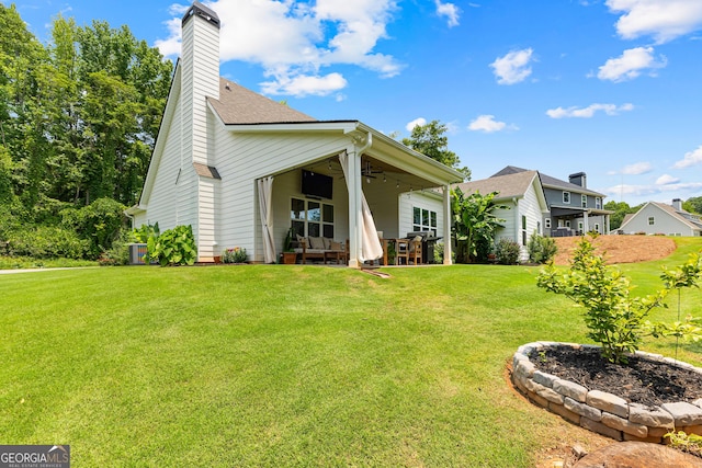 19 E Murphy St, Newnan, GA 30263 - rear view of house with ceiling fan, a lawn, a chimney, and a patio area