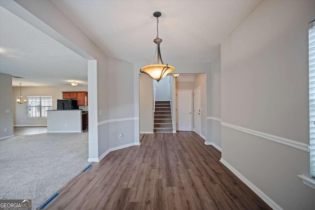 3223 Tallon Ln SW, Atlanta, GA 30311 - unfurnished dining area with stairs, dark wood-type flooring, and baseboards