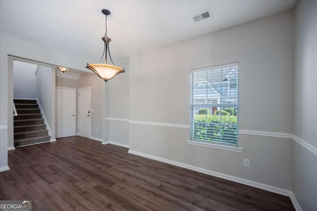3223 Tallon Ln SW, Atlanta, GA 30311 - unfurnished room featuring stairs, dark wood-style floors, and baseboards