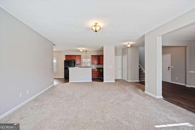 3223 Tallon Ln SW, Atlanta, GA 30311 - unfurnished living room featuring stairway, carpet flooring, and baseboards