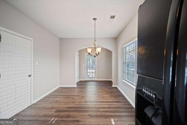 3223 Tallon Ln SW, Atlanta, GA 30311 - unfurnished dining area with arched walkways, a chandelier, dark wood-style flooring, and baseboards