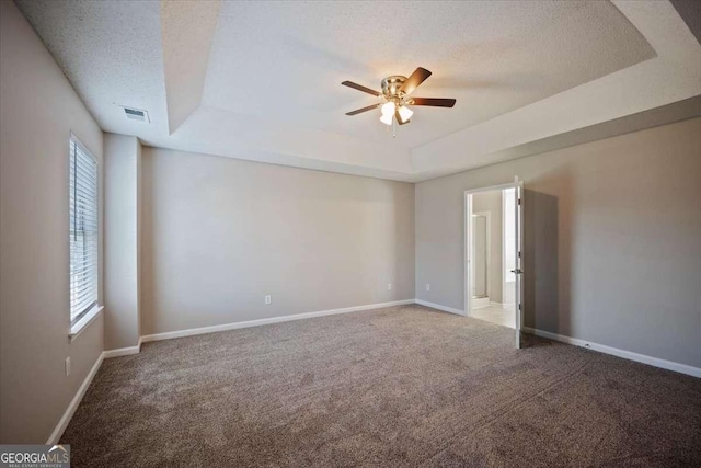 3223 Tallon Ln SW, Atlanta, GA 30311 - carpeted spare room with a tray ceiling, ceiling fan, healthy amount of natural light, and a textured ceiling