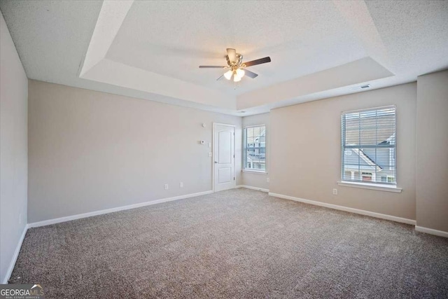 3223 Tallon Ln SW, Atlanta, GA 30311 - spare room with a raised ceiling, ceiling fan, carpet, baseboards, and a textured ceiling