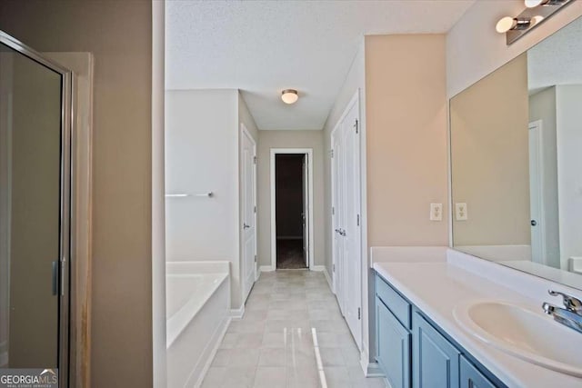 3223 Tallon Ln SW, Atlanta, GA 30311 - full bath with vanity, a garden tub, a stall shower, and baseboards