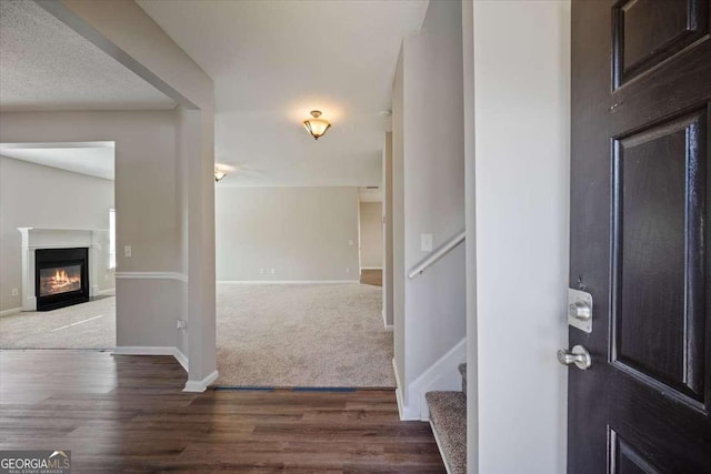3223 Tallon Ln SW, Atlanta, GA 30311 - carpeted foyer entrance featuring wood finished floors, baseboards, a glass covered fireplace, and stairway