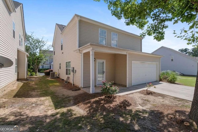 3223 Tallon Ln SW, Atlanta, GA 30311 - traditional-style house with cooling unit, concrete driveway, and an attached garage