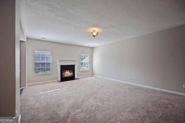 3223 Tallon Ln SW, Atlanta, GA 30311 - unfurnished living room with carpet, a textured ceiling, a fireplace with flush hearth, and baseboards