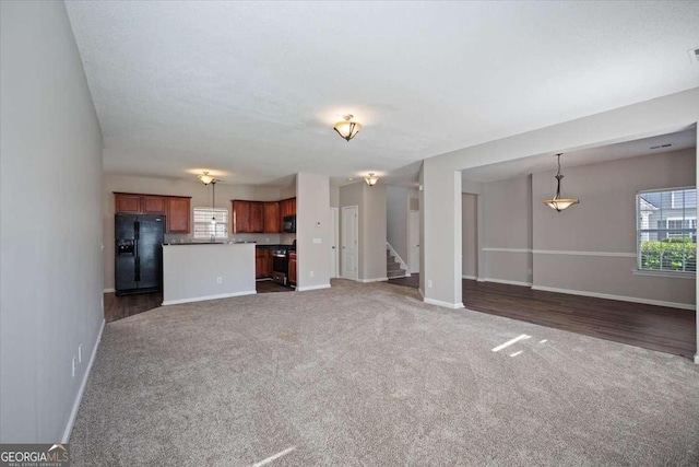 3223 Tallon Ln SW, Atlanta, GA 30311 - unfurnished living room featuring dark carpet, stairs, and baseboards