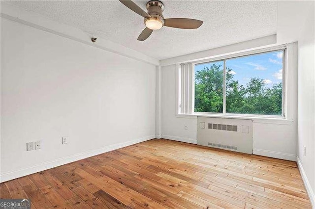 2479 Peachtree Rd NE Unit 305, Atlanta, GA 30305 - empty room featuring radiator, a textured ceiling, hardwood / wood-style floors, and ceiling fan