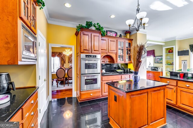 1214 Greenridge Ln, Lithonia, GA 30058 - kitchen with a chandelier, stainless steel appliances, crown molding, a center island, and glass insert cabinets