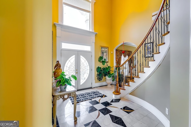 1214 Greenridge Ln, Lithonia, GA 30058 - foyer with a high ceiling, stairs, baseboards, and tile patterned flooring
