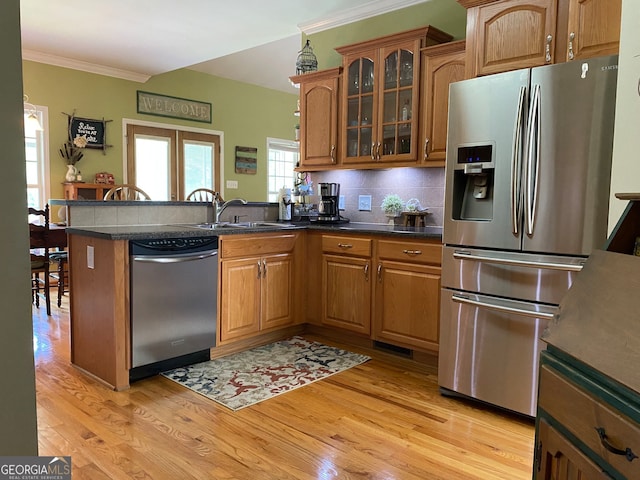 475 Harbour Shores Dr, Jackson, GA 30233 - kitchen with appliances with stainless steel finishes, a peninsula, ornamental molding, brown cabinets, and a sink