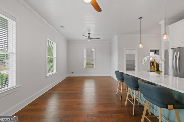 435 New St, Macon, GA 31201 - kitchen featuring freestanding refrigerator, ceiling fan, a kitchen breakfast bar, dark wood-style floors, and ornamental molding