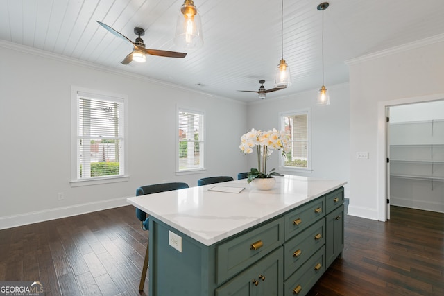 435 New St, Macon, GA 31201 - kitchen with green cabinetry, a ceiling fan, a kitchen bar, dark wood-style flooring, and crown molding