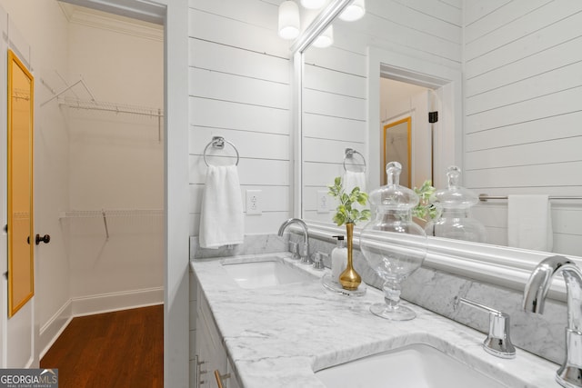 435 New St, Macon, GA 31201 - full bath featuring double vanity, wood finished floors, a spacious closet, and wooden walls