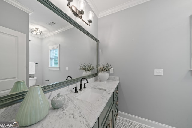 435 New St, Macon, GA 31201 - bathroom with ornamental molding, vanity, baseboards, and toilet