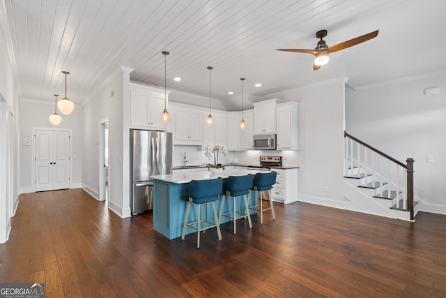 435 New St, Macon, GA 31201 - kitchen featuring stainless steel appliances, crown molding, a kitchen bar, white cabinets, and a ceiling fan