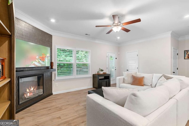 153 Witter Way, Woodstock, GA 30188 - living area with a fireplace, light wood finished floors, ceiling fan, recessed lighting, and crown molding