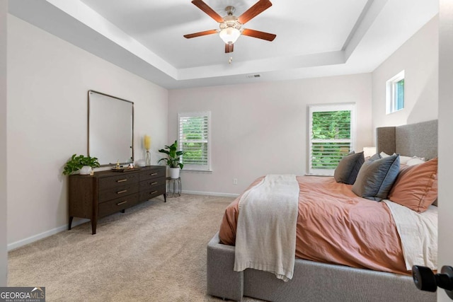 153 Witter Way, Woodstock, GA 30188 - bedroom featuring a tray ceiling, multiple windows, light colored carpet, and ceiling fan
