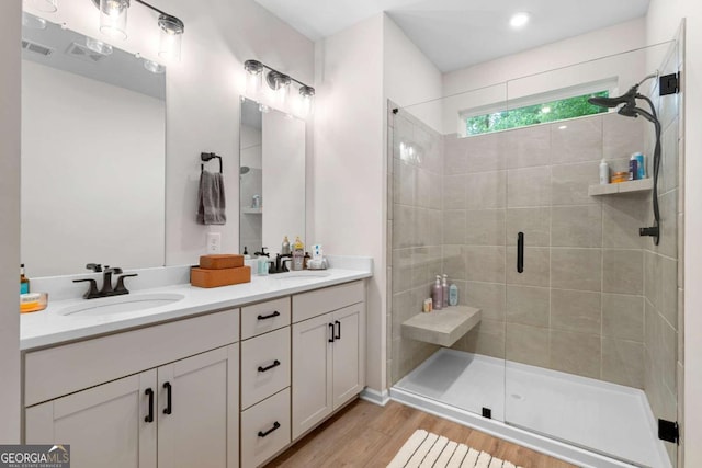 153 Witter Way, Woodstock, GA 30188 - bathroom with double vanity, a shower stall, and wood finished floors