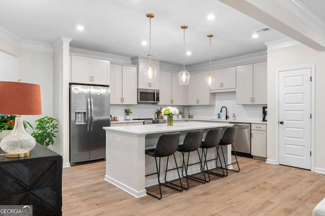 153 Witter Way, Woodstock, GA 30188 - kitchen featuring stainless steel appliances, a kitchen island, light countertops, backsplash, and a breakfast bar