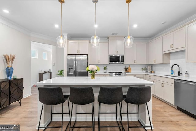 153 Witter Way, Woodstock, GA 30188 - kitchen featuring stainless steel appliances, a center island, ornamental molding, backsplash, and a kitchen bar