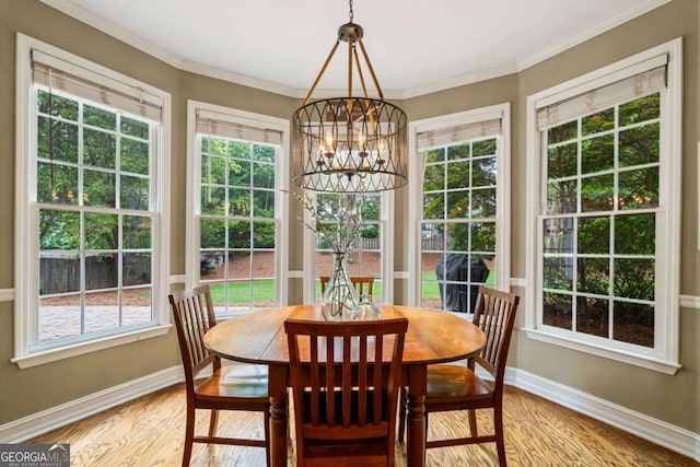 6695 Buckingham Cir, Cumming, GA 30040 - dining area with a chandelier, light wood-type flooring, healthy amount of natural light, and crown molding