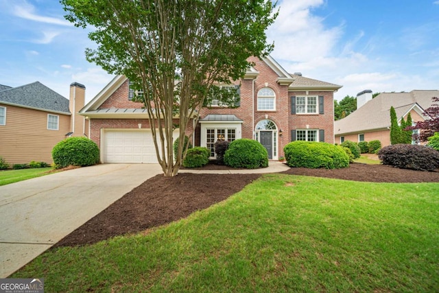 6695 Buckingham Cir, Cumming, GA 30040 - colonial inspired home with brick siding, concrete driveway, and a front yard