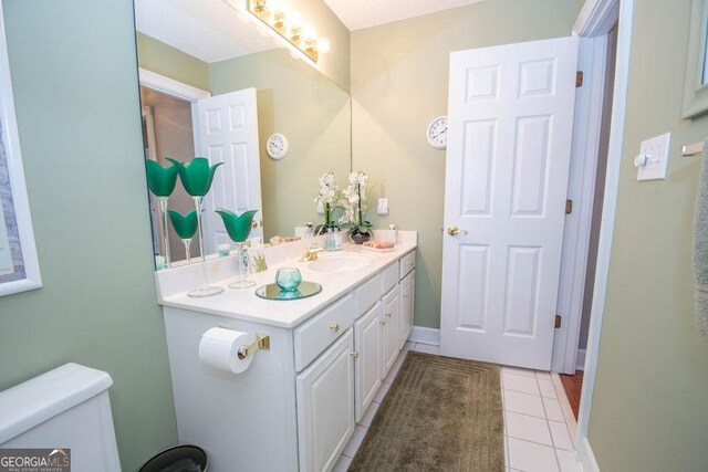 215 Fairway Ct, Newnan, GA 30265 - bathroom featuring vanity, toilet, tile patterned floors, and baseboards