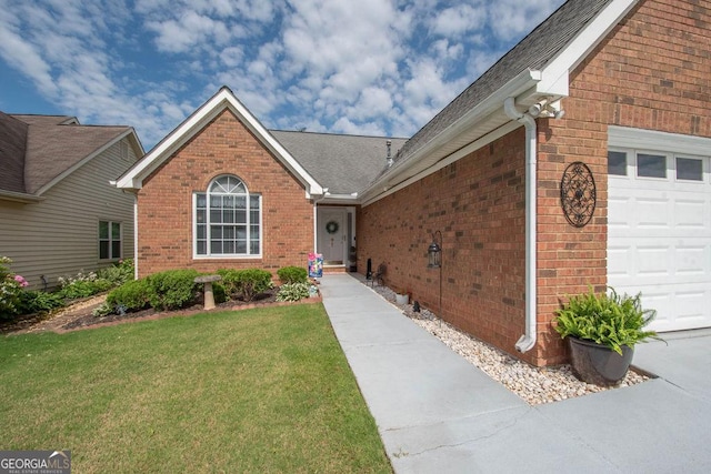 215 Fairway Ct, Newnan, GA 30265 - view of exterior entry featuring brick siding, an attached garage, a yard, and roof with shingles