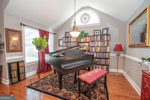215 Fairway Ct, Newnan, GA 30265 - living area with lofted ceiling, wood finished floors, and baseboards