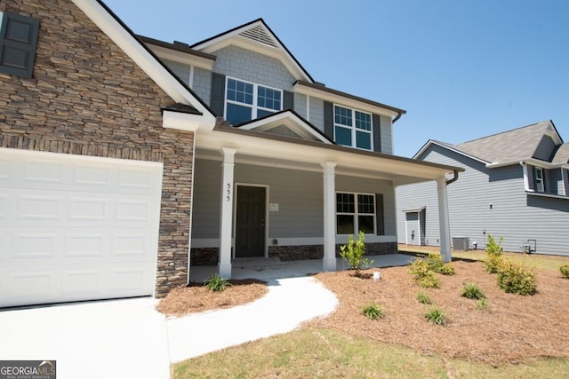 280 River Run Dr Unit 79, Dallas, GA 30132 - view of front facade featuring stone siding, a porch, an attached garage, and central air condition unit