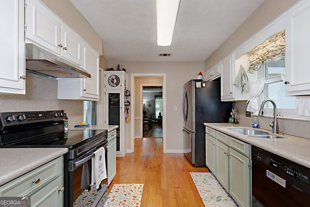 100 Huntcliff Ct, Lagrange, GA 30240 - kitchen featuring black appliances, under cabinet range hood, light wood-style flooring, and light countertops