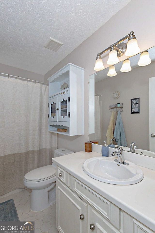 100 Huntcliff Ct, Lagrange, GA 30240 - bathroom with vanity, tile patterned floors, and a textured ceiling