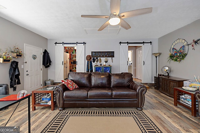 100 Huntcliff Ct, Lagrange, GA 30240 - living area featuring a barn door, ceiling fan, and wood finished floors