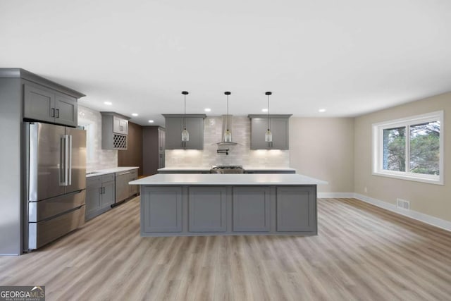 1120 Taliwa Trl NE, Marietta, GA 30068 - kitchen with appliances with stainless steel finishes, gray cabinets, light countertops, light wood finished floors, and backsplash