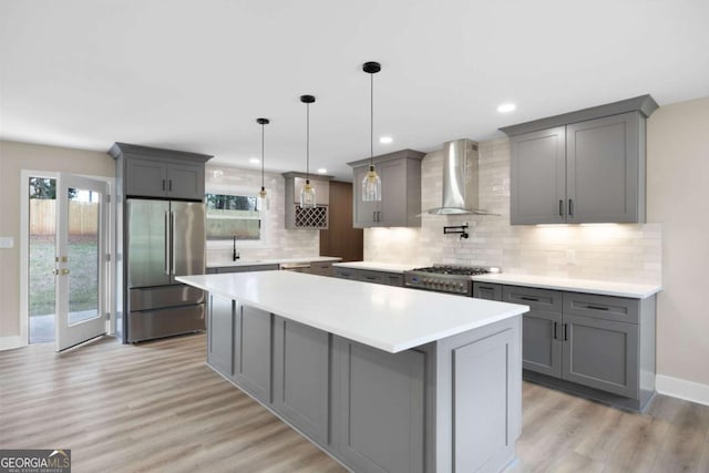 1120 Taliwa Trl NE, Marietta, GA 30068 - kitchen with wall chimney exhaust hood, high end appliances, gray cabinets, a kitchen island, and light wood-style flooring