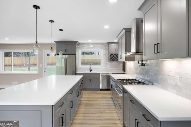 1120 Taliwa Trl NE, Marietta, GA 30068 - kitchen with appliances with stainless steel finishes, gray cabinetry, wall chimney exhaust hood, healthy amount of natural light, and recessed lighting