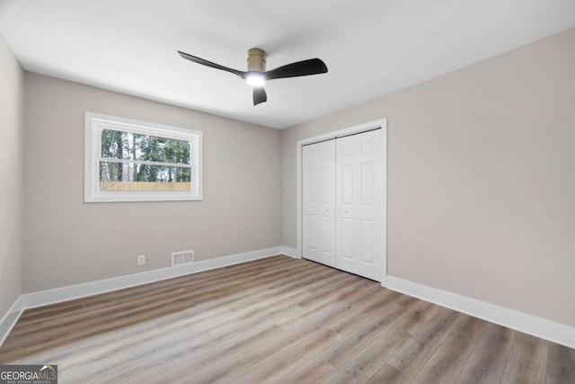 1120 Taliwa Trl NE, Marietta, GA 30068 - unfurnished bedroom with wood finished floors, a closet, and a ceiling fan