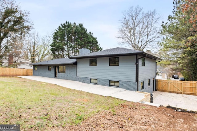 1120 Taliwa Trl NE, Marietta, GA 30068 - rear view of house featuring a patio, a chimney, and a gate