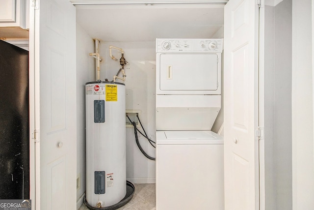 1445 Monroe Dr NE Unit F10, Atlanta, GA 30324 - laundry area featuring electric water heater, stacked washing machine and dryer, and tile patterned floors