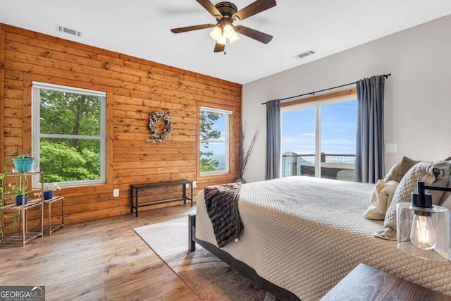 191 Rimrock Rd Unit 63, Jasper, GA 30143 - bedroom featuring multiple windows, wood finished floors, wood walls, and a ceiling fan