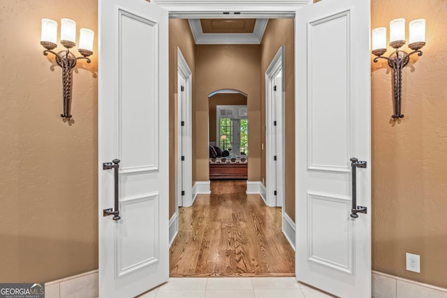 1031 Sugar Run, Greensboro, GA 30642 - corridor with ornamental molding, arched walkways, and light wood-style flooring