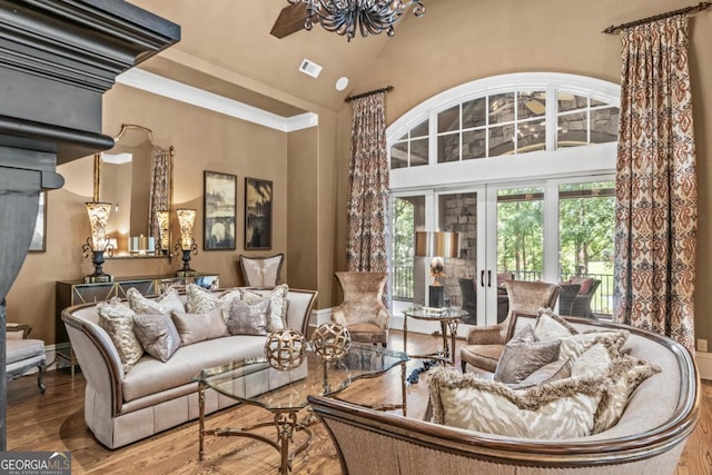1031 Sugar Run, Greensboro, GA 30642 - living room featuring wood finished floors, high vaulted ceiling, and a chandelier